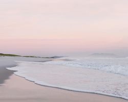 Soft waves under pink skies