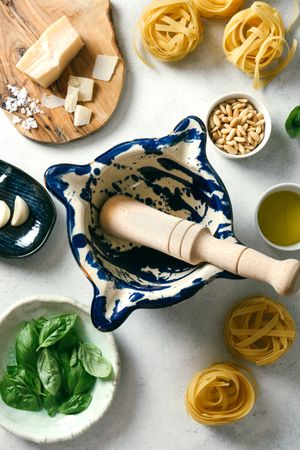Pestle and mortar with ingredients for pesto sauce