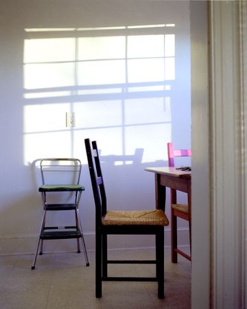 Light streaming into kitchen with chairs