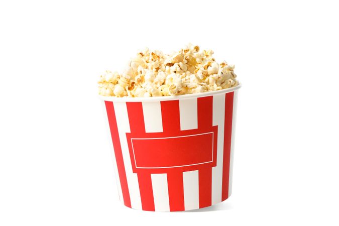 Striped bucket with popcorn isolated on blank background