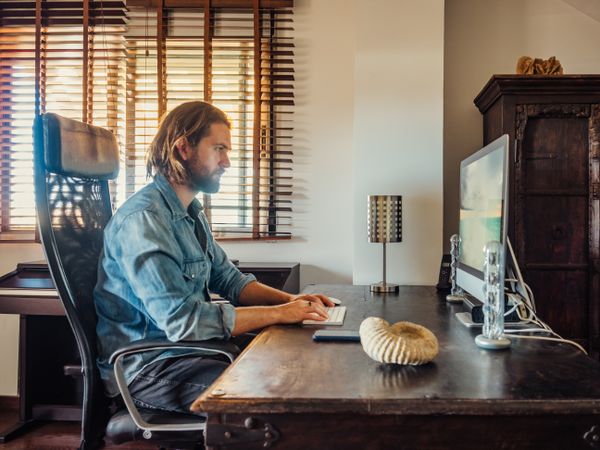 Focused man using computer in apartment