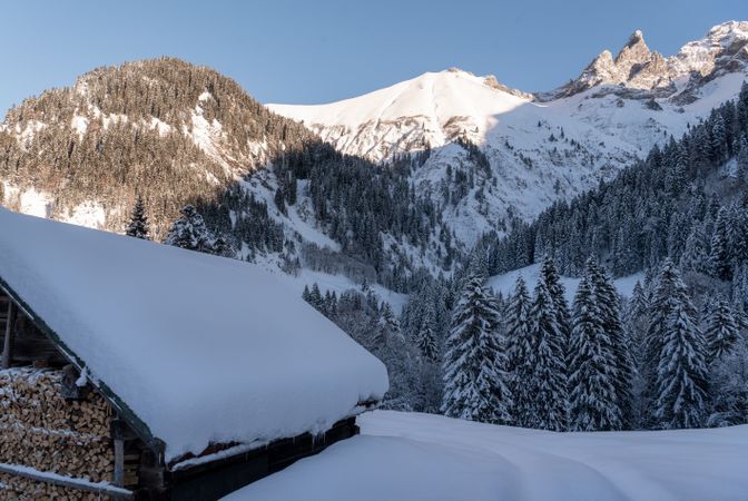 Alpine scenery with snow-covered hut and mountain peaks in Bavaria, Germany