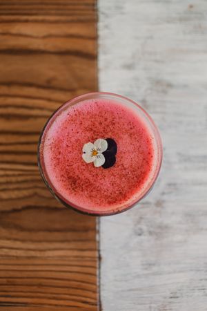 Delicious pink smoothie with frothy in glass