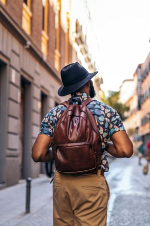 Stylish Black man walking on the city street