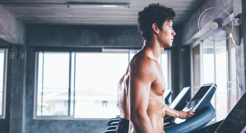 Sideview of shirtless man on treadmill