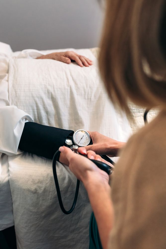 Caregiver checking blood pressure to a woman