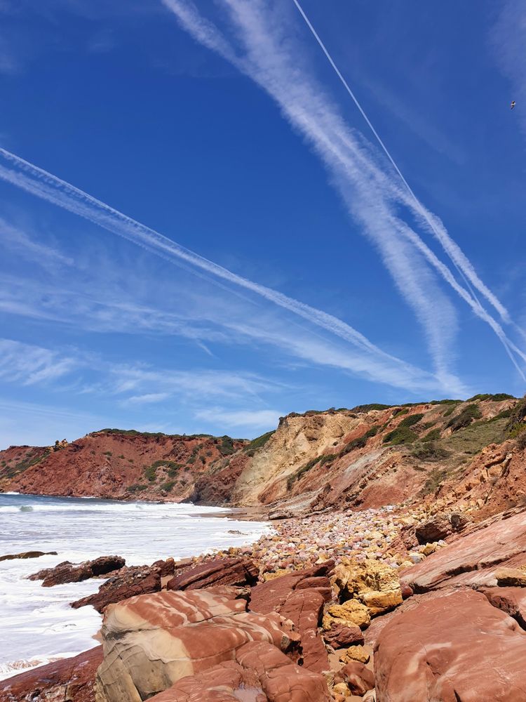 Red rocks beside ocean
