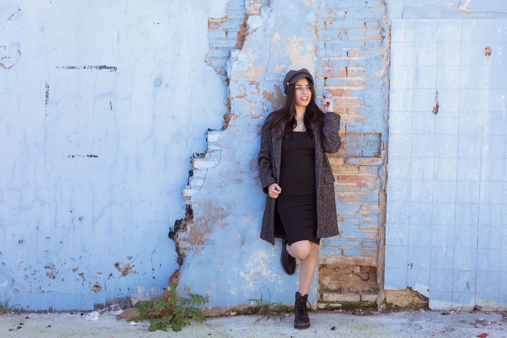 Charming Hispanic woman near wall