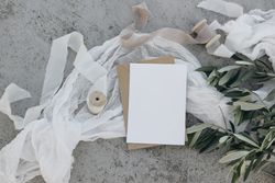 Blank greeting card, invitation template with silk ribbon and olive branches