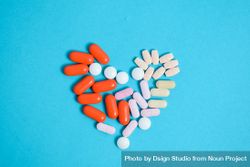 Top view of pIlls in heart shape on blue background 4267A3