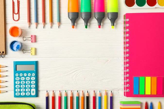Flat lay composition with school supplies on wooden background, space for text