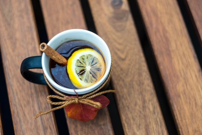 Mug of tea with cinnamon stick and lemon slice