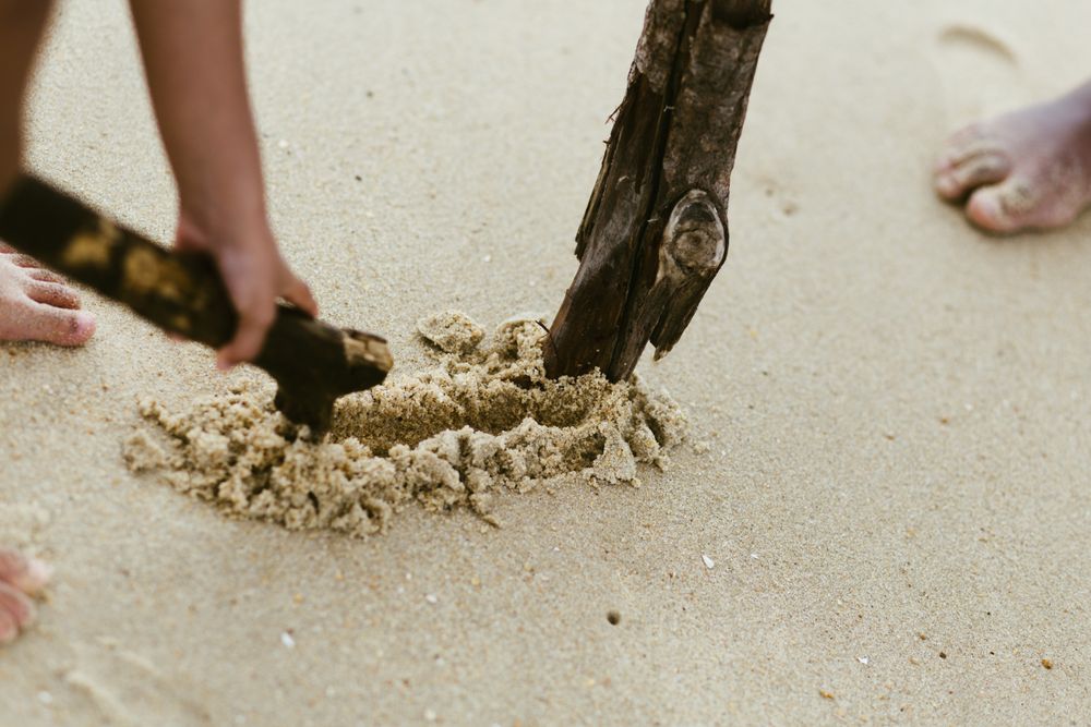 Crop Black boy playing on beach