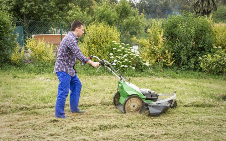 man mowing the lawn with a lawnmower