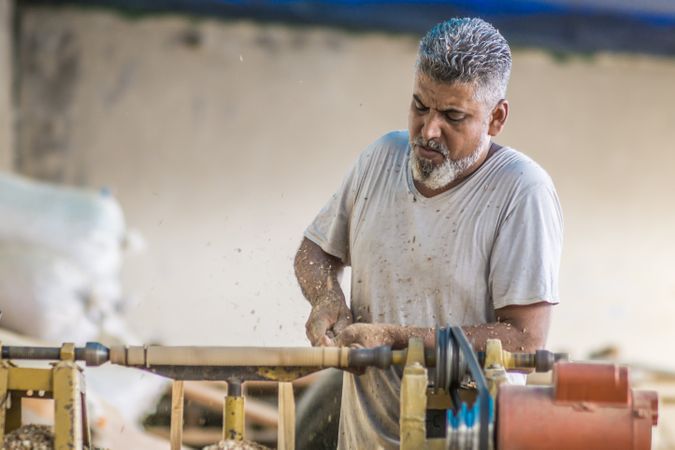 Man using woodworking machine at workplace