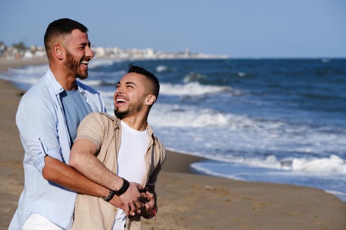 Gay couple walking on beach