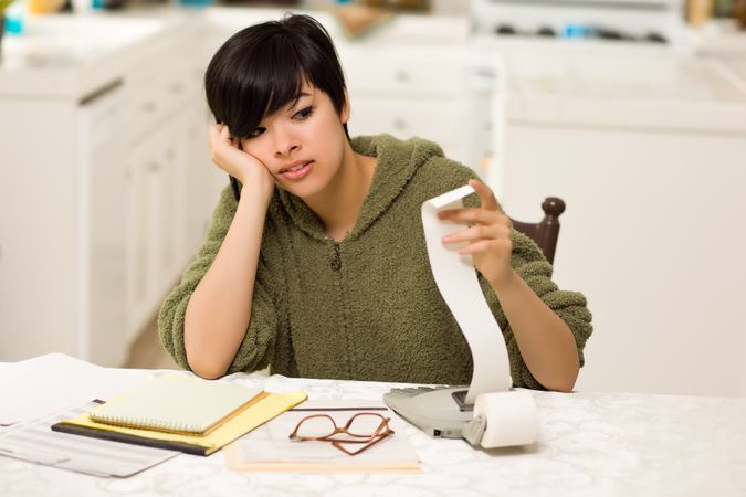 Young Woman Agonizing Over Financial Calculations