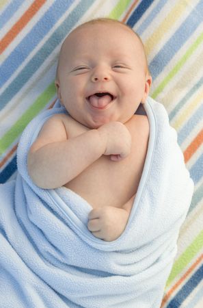 Laughing Baby Boy Wrapped in His Blanket