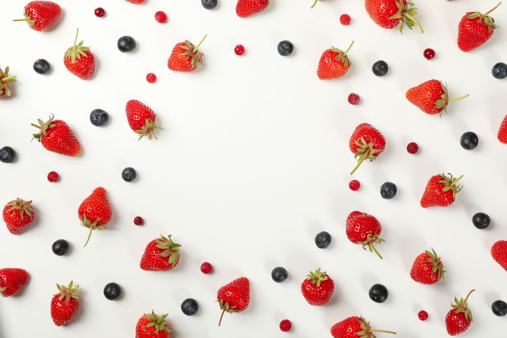 Flat lay with tasty strawberry and blueberry on plain background, top view. Summer berry