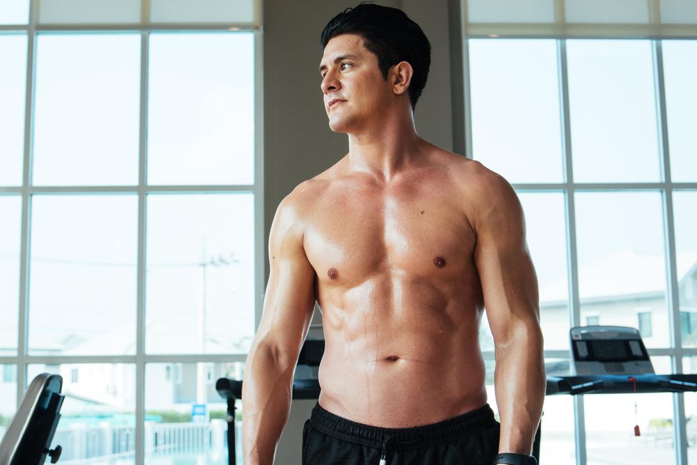 Athletic men with shit off in gym