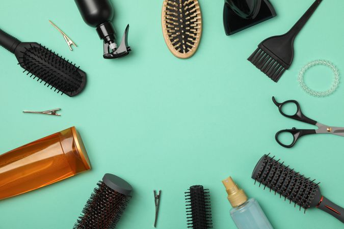 Composition with hairdresser accessories on mint background, top view