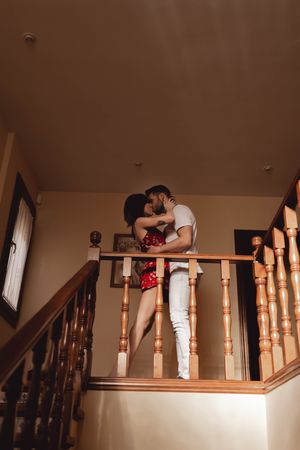 Couple kissing on stairway