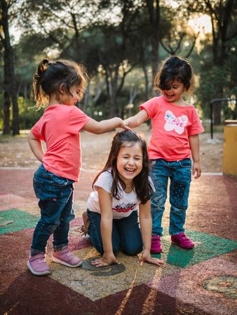 Cheerful girls having fun on playground outdoors