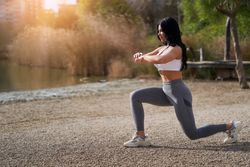 Young athlete doing squats in a gym training session