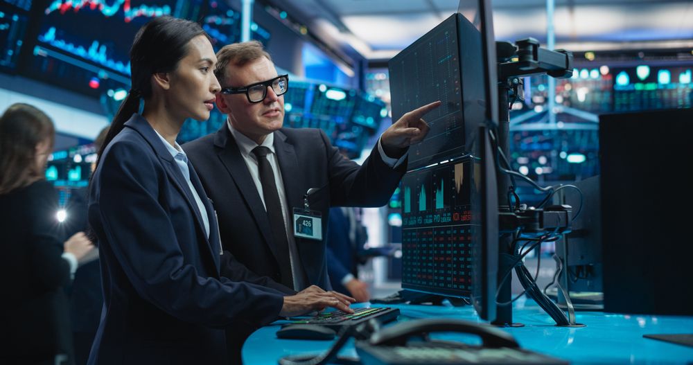 Diverse Female and Male Traders Analyzing Real-Time Financial Data and Reports About the State of the Finance Market.