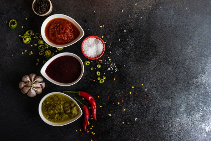 Top view of three spicy colorful Georgian condiments with copy space