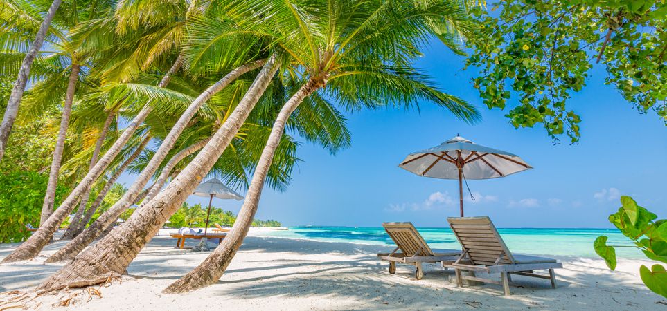 A relaxing spot on the beach with lounge chairs and parasol