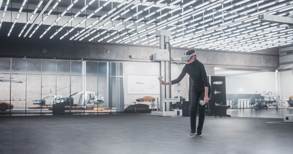 Female Car Designer Wearing Virtual Reality Headset and Using Controllers to Work on Concept Car Or Aerodynamics.