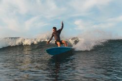 Man on surf board on waving water