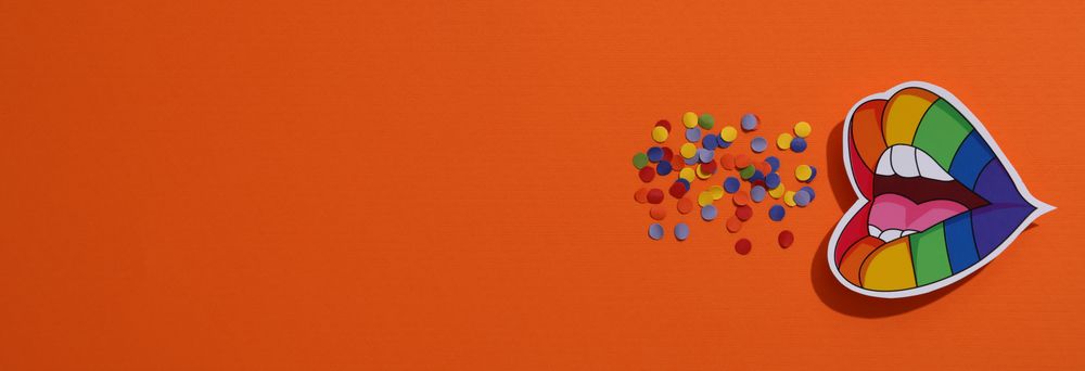 Pride parade concept, symbols on orange background.