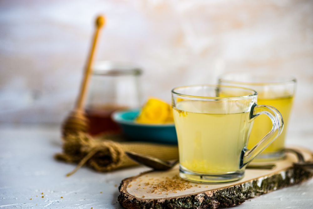 Ginger detox drinks with ingredients in background
