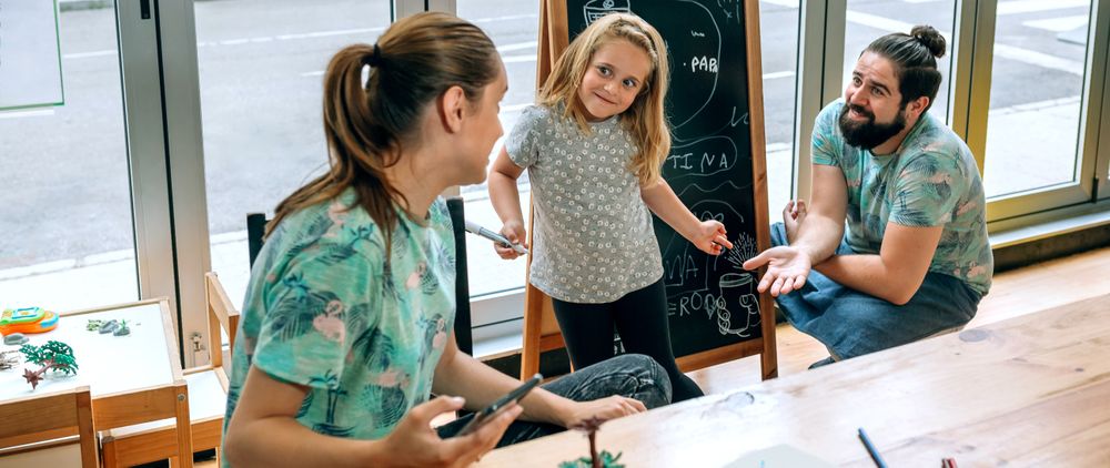 Banner of family business owners taking a break playing with daughter in their cafe restaurant