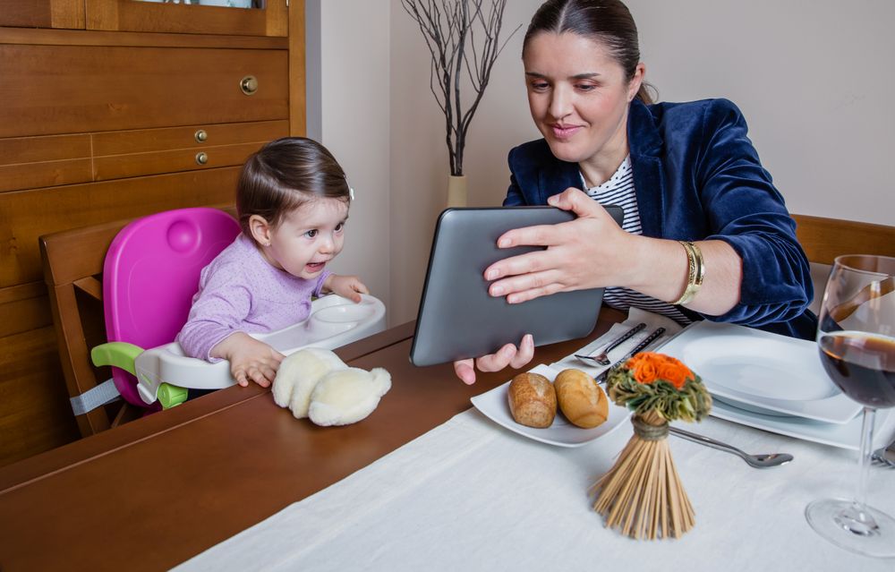 Businesswoman mother and baby girl looking tablet