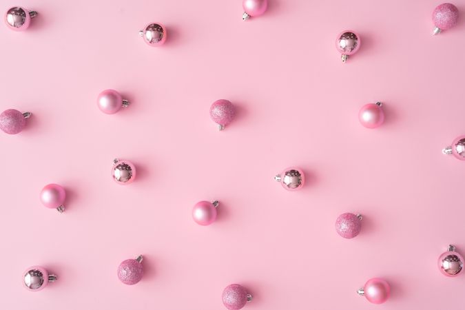 Different shades of pink baubles on a pink background