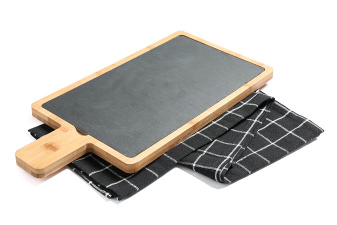 Cutting board with kitchen towel isolated on studio background