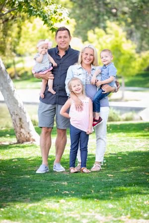 Happy Young Family Portrait In The Park