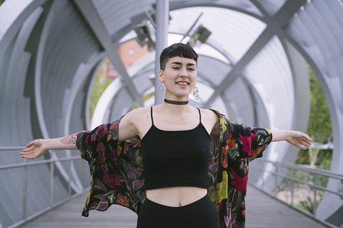 Woman in colorful shirt stretching arms