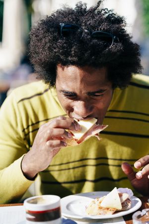 Man eating sandwich in the sun