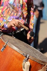 Man in floral button up shirt playing drum