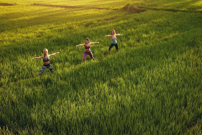 Three young women exercising in farm
