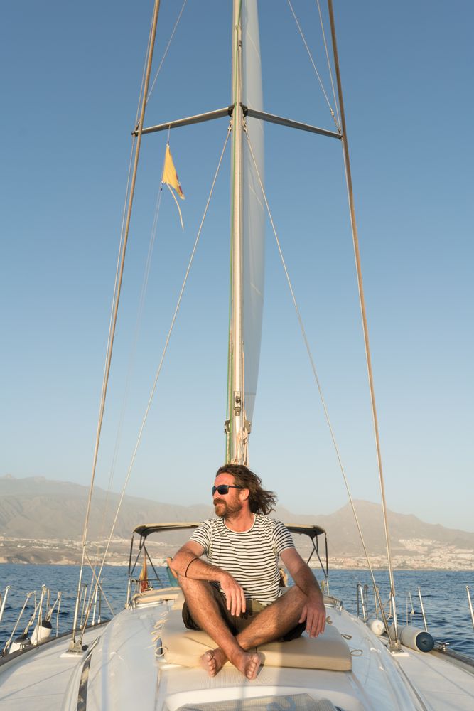 Smiling man on yacht on water