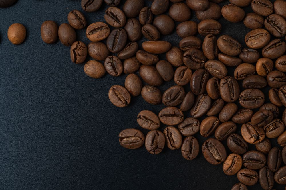 Scattered coffee beans on the side