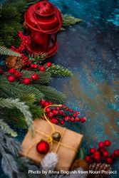 Table with fir, holly, pine and wrapped Christmas gift and decorations 5nrQm5