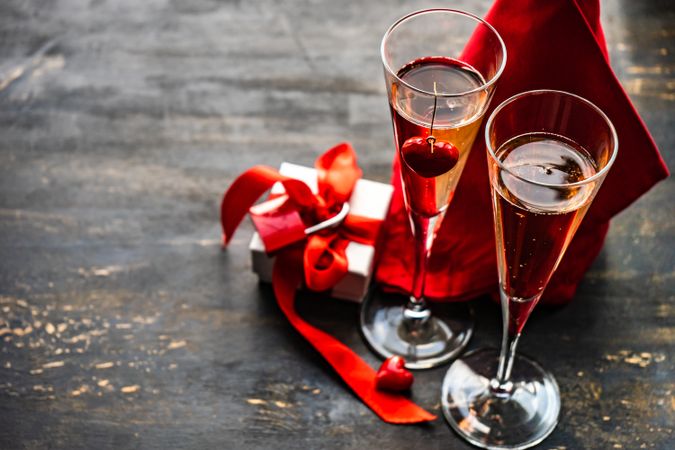 Champagne glasses with small gift box for Valentine's Day with space for text