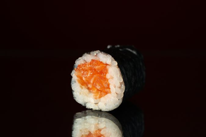 Delicious sushi roll on mirror background, close up. Japanese food