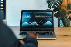 Crop Black businessman typing on laptop